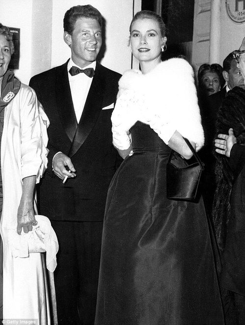 Elegant style icon wardrobe essentials: Grace Kelly in black dress with Jean-Pierre Aumont. 1955