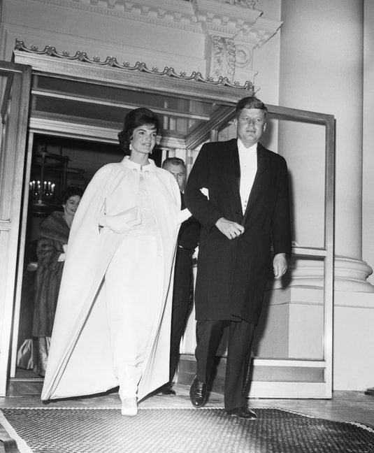 Jackie Kennedy in a silk sleeveless gown and a matching cape, with her husband John F. Kennedy, at the Inauguration Ball at White House Washington DC, 20 January 1961