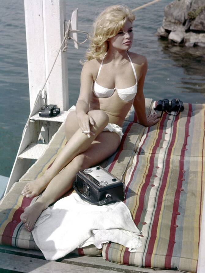 Elegant style icon wardrobe essentials: Brigitte Bardot in swimwear, a two piece bikini in white, in film « Et Dieu... créa la femme »(1956)