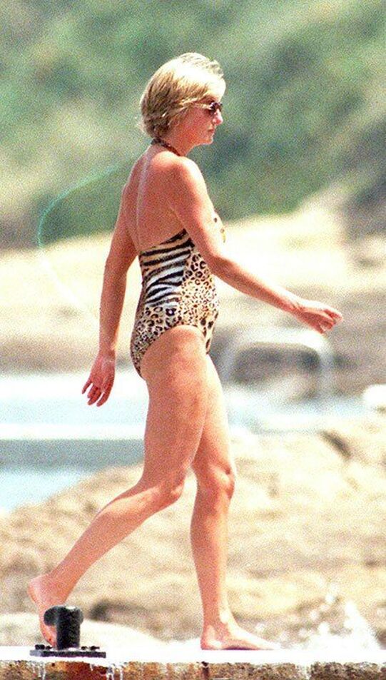 Elegant style icon wardrobe essentials: Princess Diana in swimwear, a one piece halter neck swimsuit with leopard print