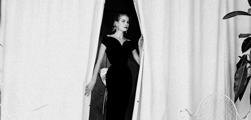 Elegant style icon wardrobe essentials: Grace Kelly in black dress, photo by Howell Conant, 1955