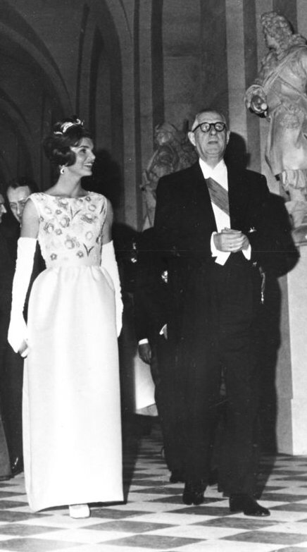 Jackie Kennedy in ivory satin dress designed by French coutourier Hubert de Givenchy, with general de Gaulle in Versailles 1961