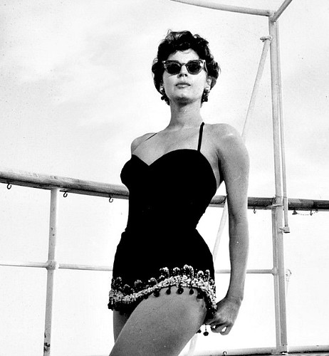 Elegant style icon wardrobe essentials: Ava Gardner in swimwear, a one piece swimsuit in black, in film The Barefoot Contessa(1954)