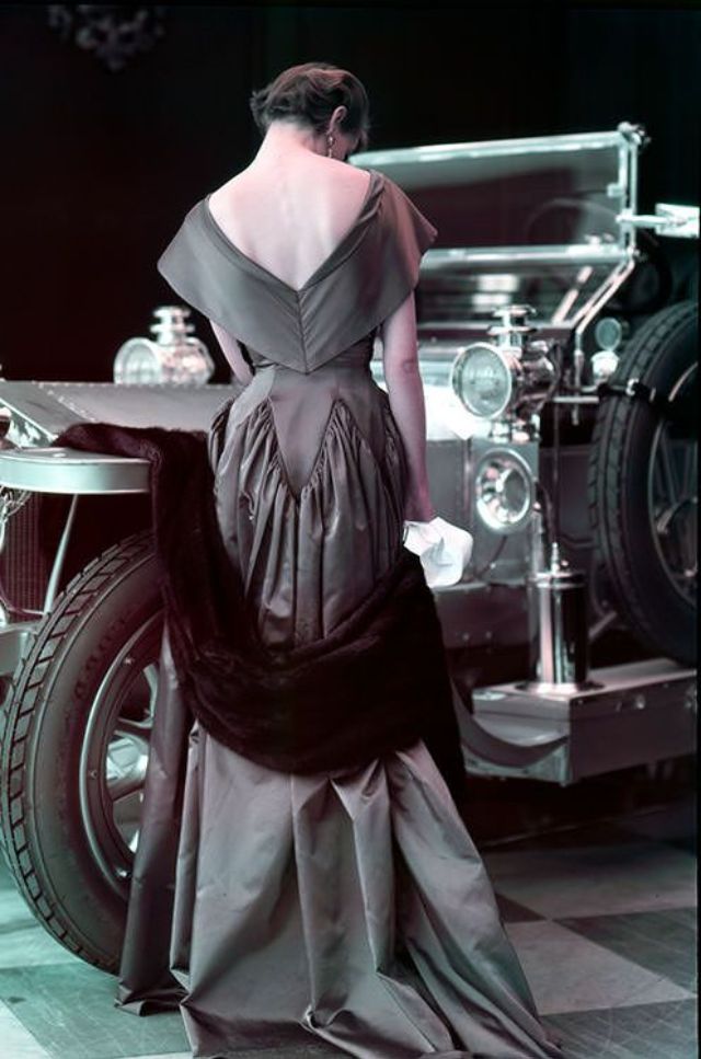 Wenda Parkinson in a Molyneux satin evening dress, posting with a 1907 Silver Ghost Rolls-Royce, photo by Norman Parkinson, 1950