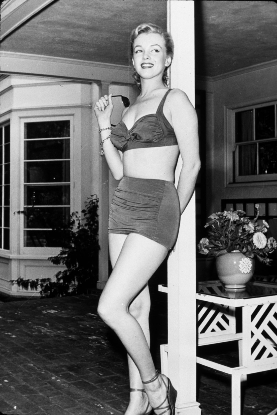 Elegant style icon wardrobe essentials: Marilyn Monroe in swimwear, a two piece bikini