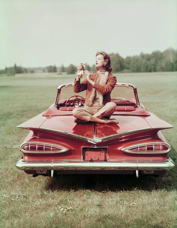 Model Sitting On A Chevrolet Convertible, photo by John Rawlings(1912-1979)