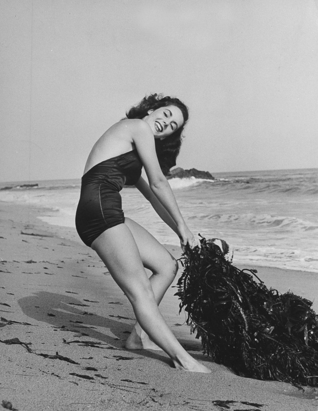 Elegant style icon wardrobe essentials: Elizabeth Taylor in swimwear, a one piece swimsuit