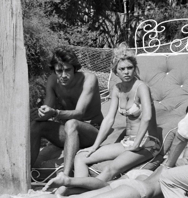 Elegant style icon wardrobe essentials: Brigitte Bardot in swimwear, a two piece bikini in floral print
