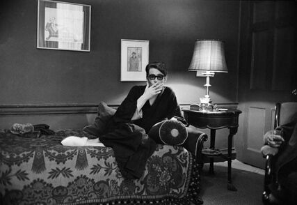 Peter O'Toole in his home smoking, 1965