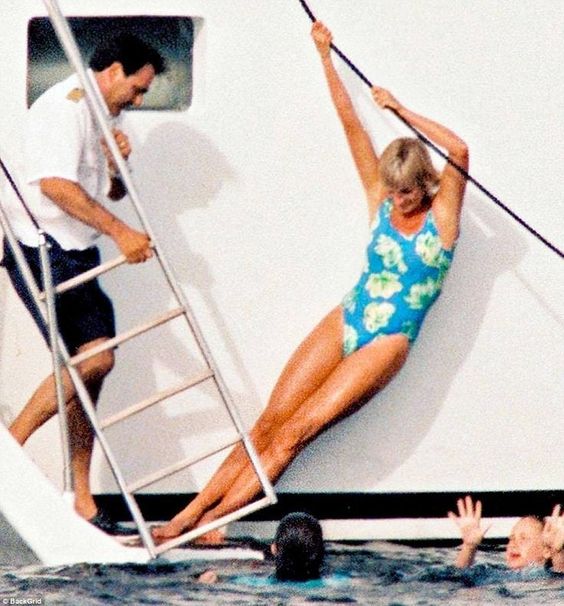 Elegant style icon wardrobe essentials: Princess Diana in swimwear, a one piece swimsuit with floral print