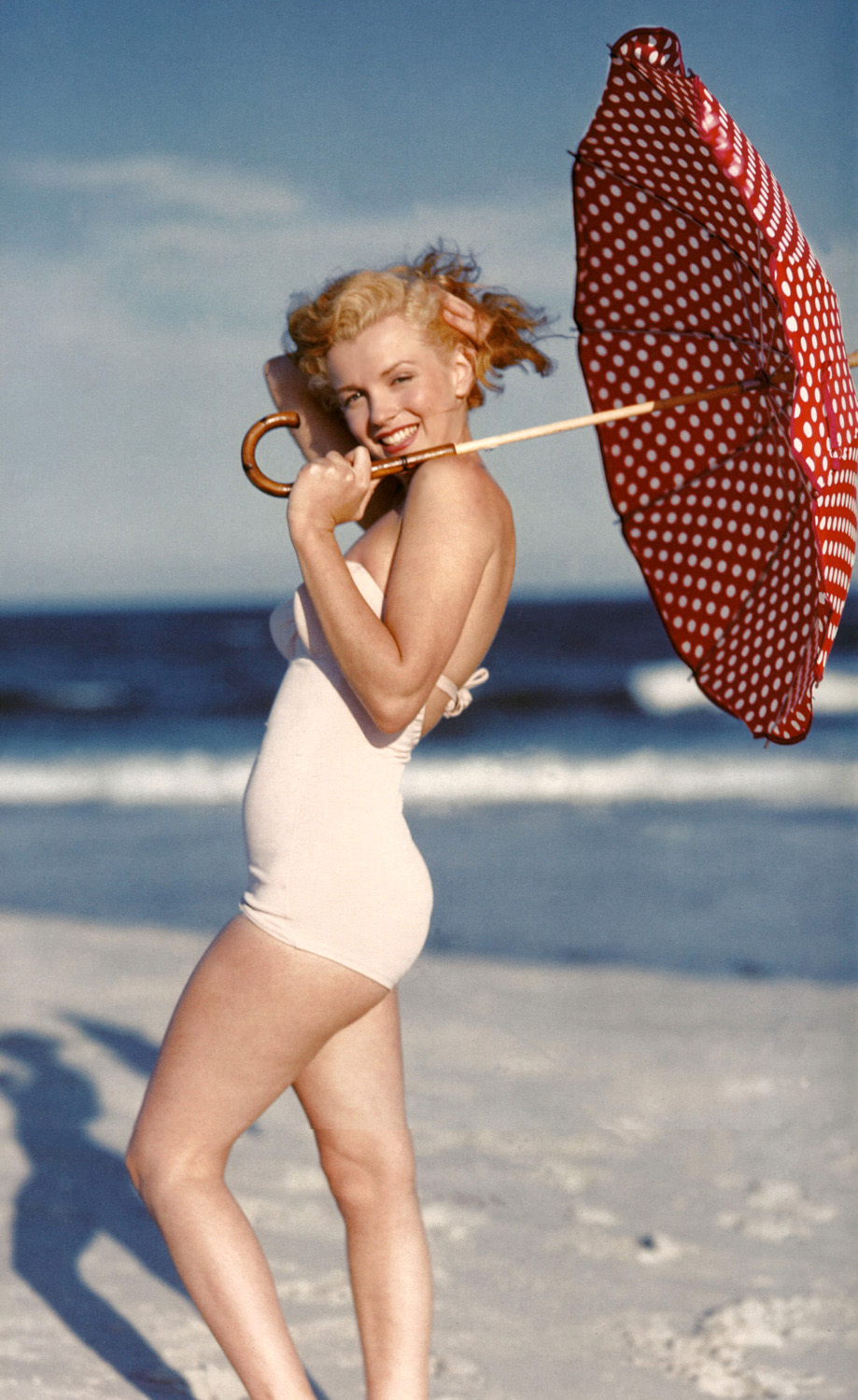 Elegant style icon wardrobe essentials: Marilyn Monroe in swimwear, a one piece pink bathing swimming suit