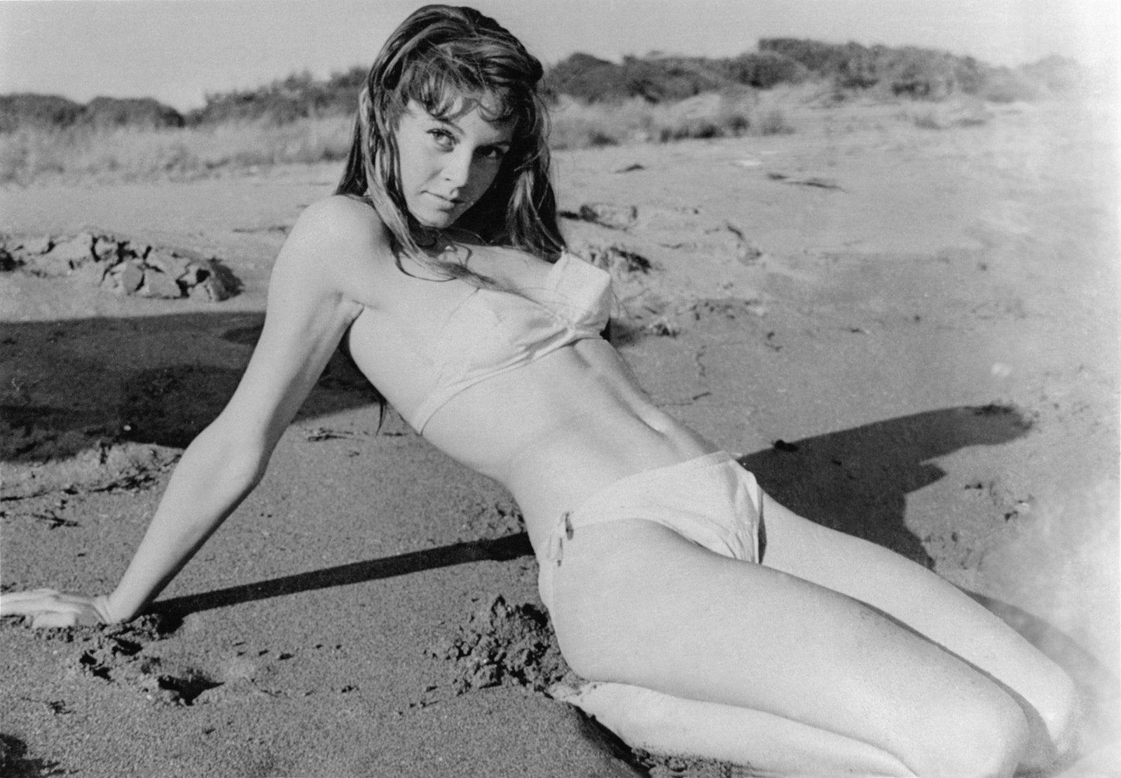 Elegant style icon wardrobe essentials: Brigitte Bardot in swimwear, a two piece bikini in white