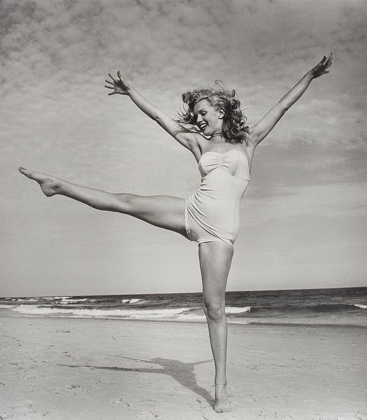 Elegant style icon wardrobe essentials: Marilyn Monroe in swimwear, a one piece pink bathing swimming suit