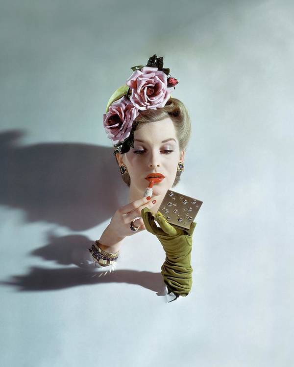 A model applying lipstick, photo by John Rawlings(1912-1979)