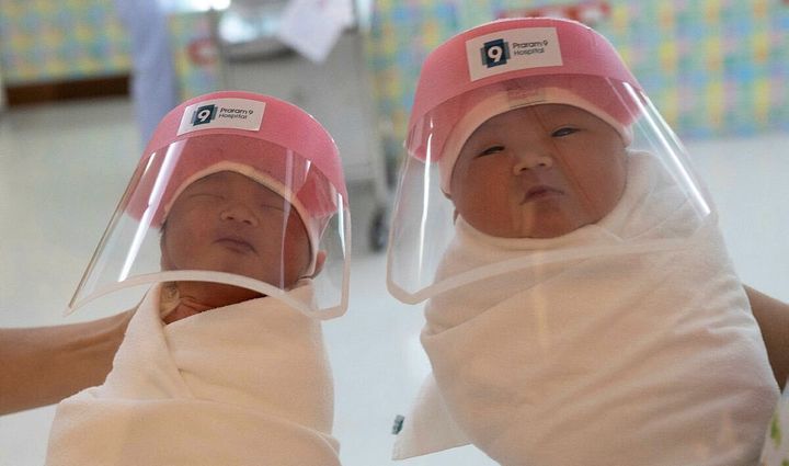 Two thailand new born babies wear face shields