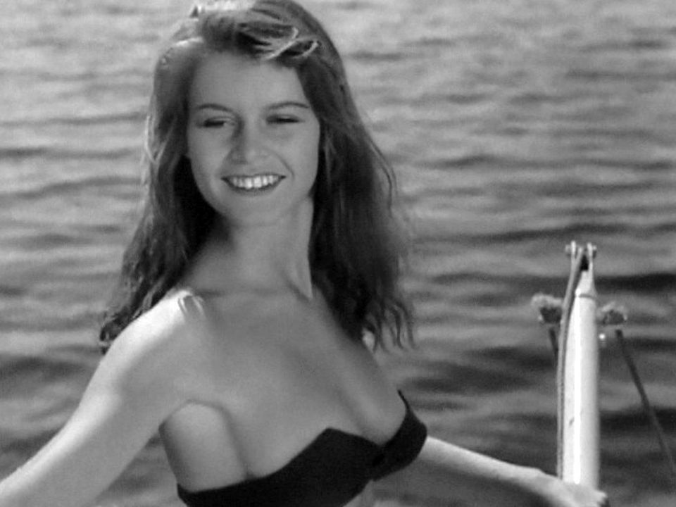 Elegant style icon wardrobe essentials: Brigitte Bardot in swimwear, a two piece bikini in black