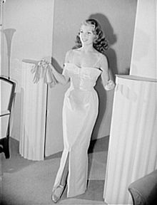 Actress Rita Hayworth models a pink and silver lamé evening gown designed by Howard Greer, 1941.