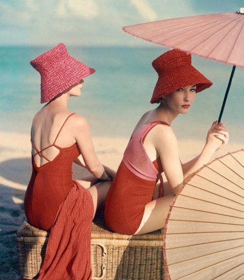 Two models wearing red bathing suits and red hats, velvet dress, photo by John Rawlings(1912-1979)