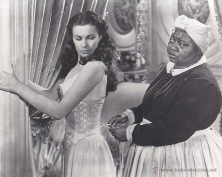 Vivien Leigh as Scarlet O’Hara in Gone with the Wind, wearing corset with the help of her maid