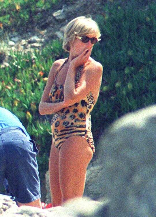 Elegant style icon wardrobe essentials: Princess Diana in swimwear, a one piece halter neck swimsuit with leopard print