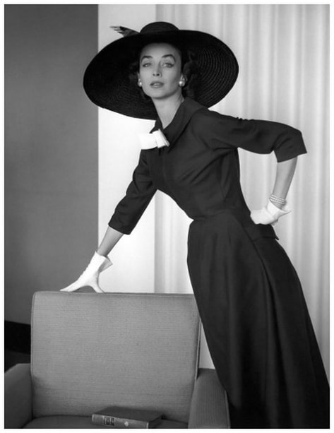 Dorian Leigh (April 23, 1917 – July 7, 2008), the first American supermodel, in black dress with three quarter sleeves, 1954
