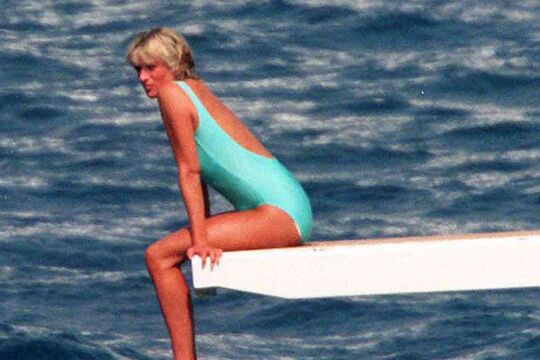 Elegant style icon wardrobe essentials: Princess Diana in swimwear, a one piece pale blue swimsuit