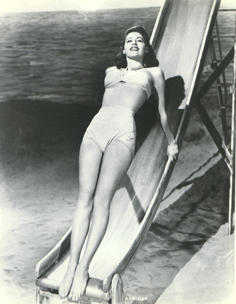 Elegant style icon wardrobe essentials: Ava Gardner in swimwear, a two piece bikini in solid color