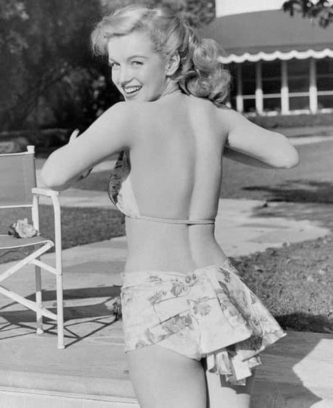 Elegant style icon wardrobe essentials: Marilyn Monroe in swimwear, a two piece halter neck bikini