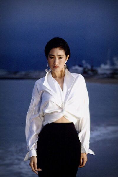 Elegant style icon wardrobe essentials: Gongli(鞏俐)in white shirt:Gong Li in white shirt, Cannes, France, 1993
