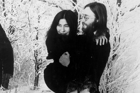 John Lennon holding his wife Yoko Uno , 1970s