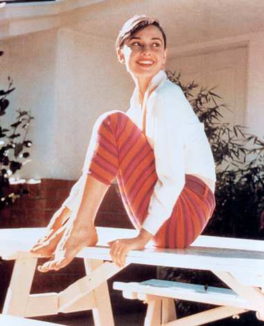 Audrey Hepburn in white shirt and striped capri pant