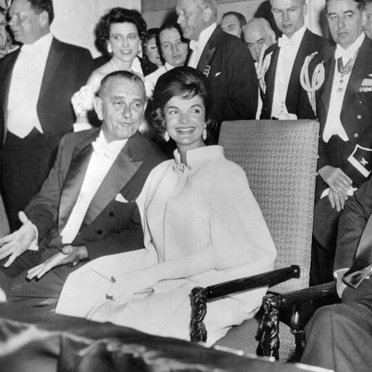 Jackie Kennedy in a silk sleeveless gown and a matching cape, at the Inauguration Ball at White House Washington DC, 20 January 1961