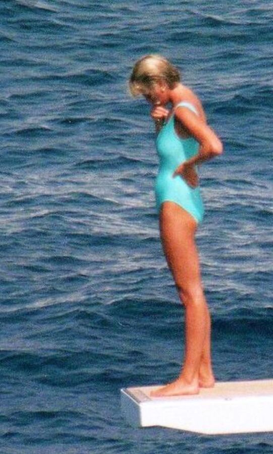 Elegant style icon wardrobe essentials: Princess Diana in swimwear, a one piece pale blue swimsuit