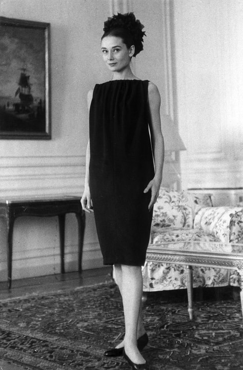 Elegant style icon wardrobe essentials: Audrey Hepburn in black dress in her suite at the Hotel Hassler Rome Italy, 1958