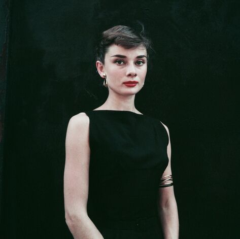 Elegant style icon wardrobe essentials: Audrey Hepburn in little black dress on the set of film Sabrina, 1953