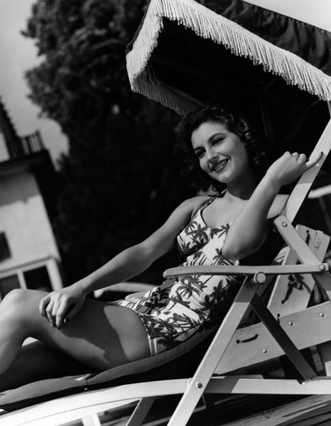 Elegant style icon wardrobe essentials: Ava Gardner in swimwear, a one piece swimsuit in print