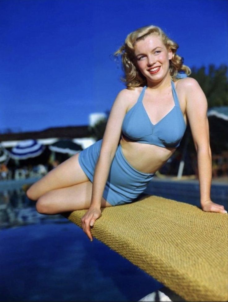 Elegant style icon wardrobe essentials: Marilyn Monroe in swimwear, a two piece halter neck bikini