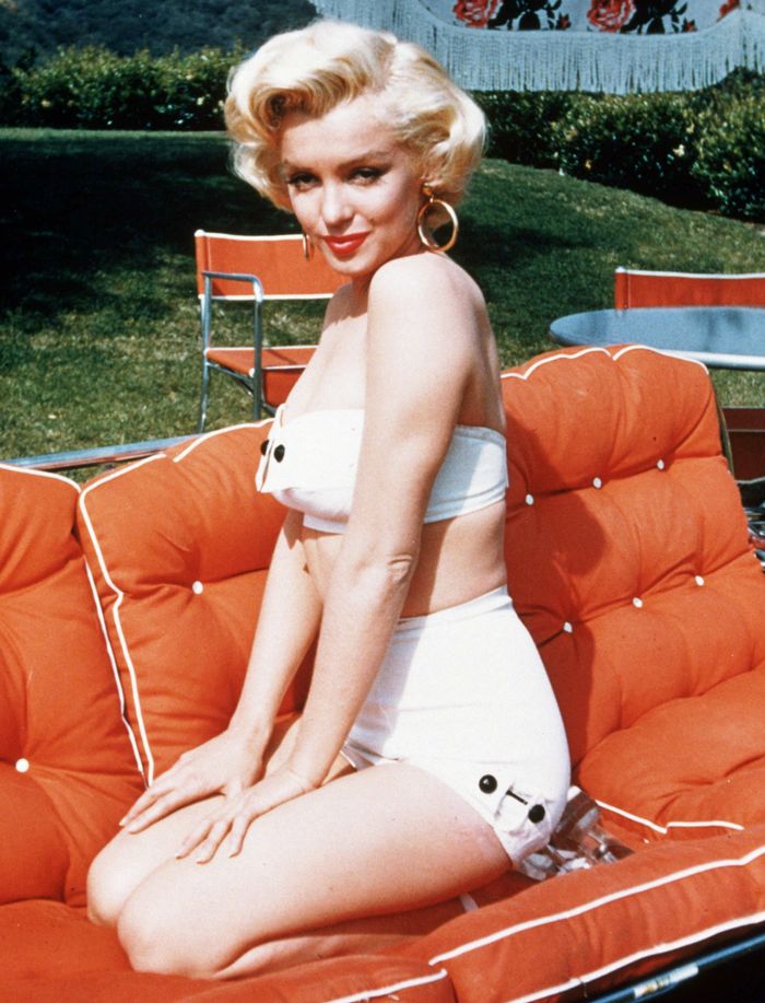 Elegant style icon wardrobe essentials: Marilyn Monroe in swimwear, a two piece strapless bikini