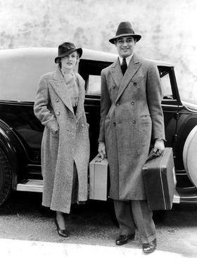 Cary Grant and his first wife Virginia Cherrill in coats preparing for voyage, 1932