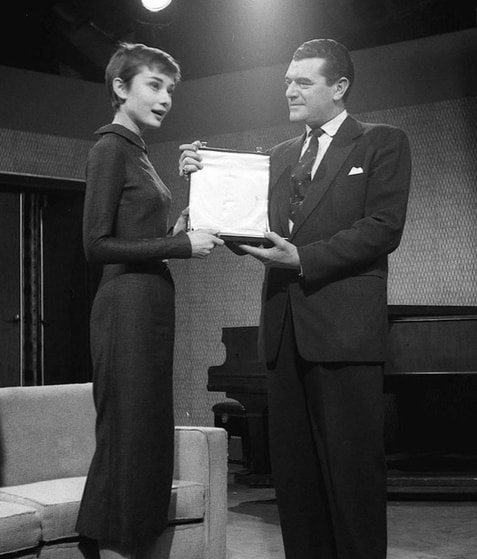 Elegant style icon wardrobe essentials: Audrey Hepburn in little black dress, 1955