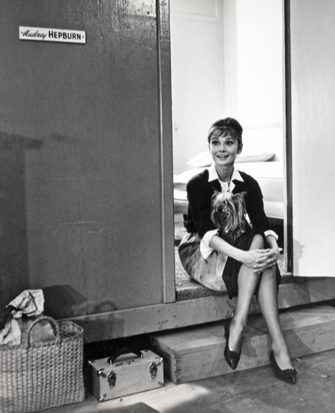 Elegant style icon wardrobe essentials: Audrey Hepburn in cardigan sweater, on the set of film The Children's Hour, 1961