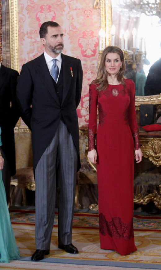 Princess Letizia of Spain in dark red long sleeve floor length gown with her husband Prince Felipe VI at the Foreign Ambassadors annual reception, Royal Palace