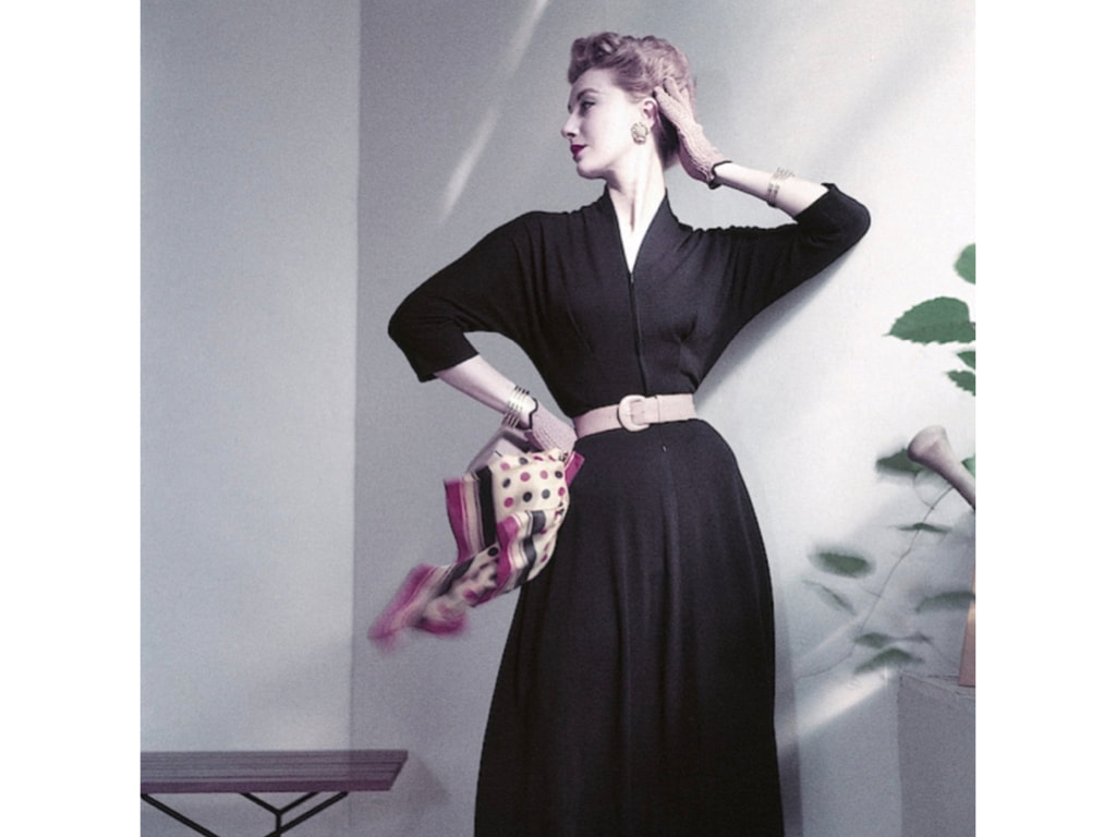 Sue Jenks in a navy blue jersey dress cinched at the waist with a blonde calf belt,Vogue March 1st, 1952, © Frances McLaughlin-Gill