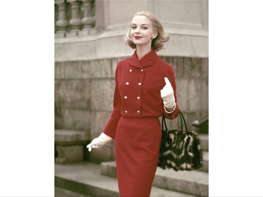 Gretchen Harris,in a red suit by Junior Sophisticates, fur purse by Greta, gloves by Superb and bracelet by Arpad, Glamour, August 1956© Frances McLaughlin-Gill