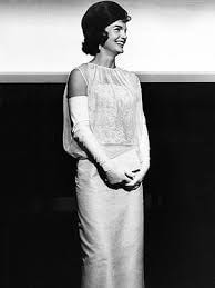 Jackie Kennedy Onassis wearing sleeveless inauguration gown designed by Oleg Cassini
