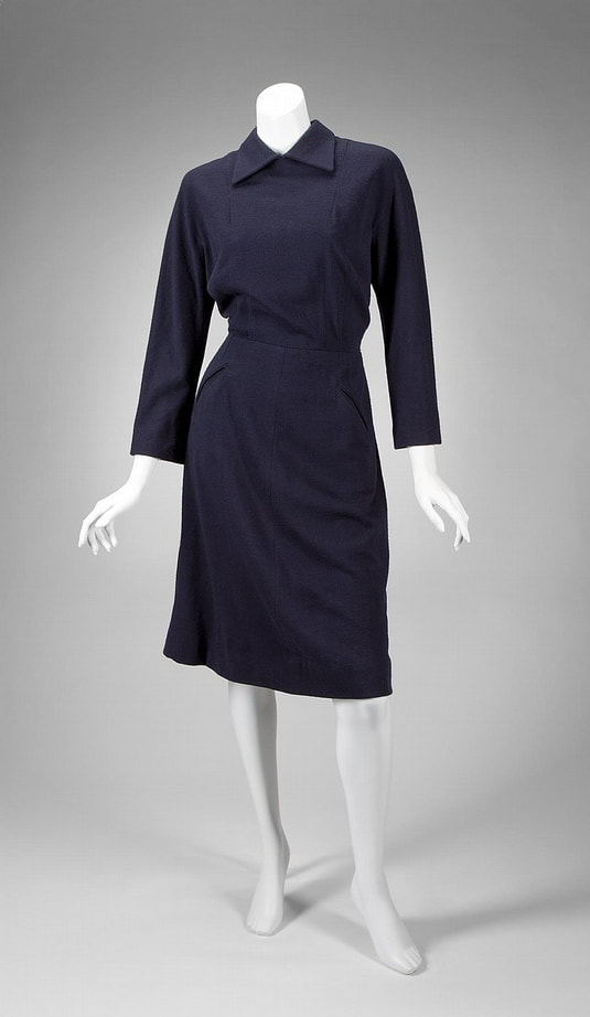 PictureA long-sleeve navy blue wool dress with attached collar, believed by the estate to have been made for Greta Garbo by Valentina. Zipper closure at back, mid-calf length.