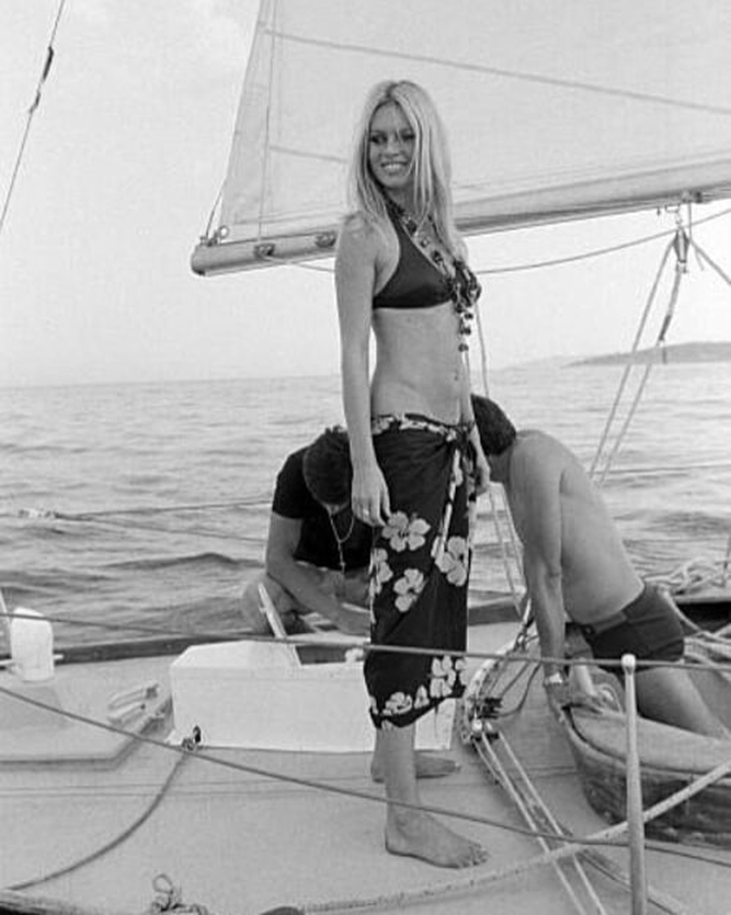 Elegant style icon wardrobe essentials: Brigitte Bardot in swimwear, a two piece bikini in black, August 1968