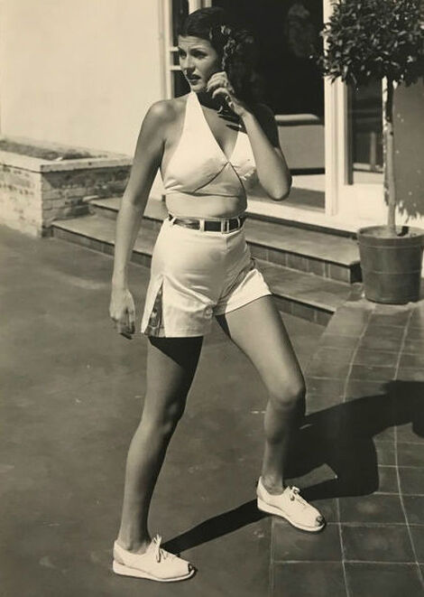 Elegant style icon wardrobe essentials: A pair of high-waist shorts: Rita Hayworth in a pair of shorts 