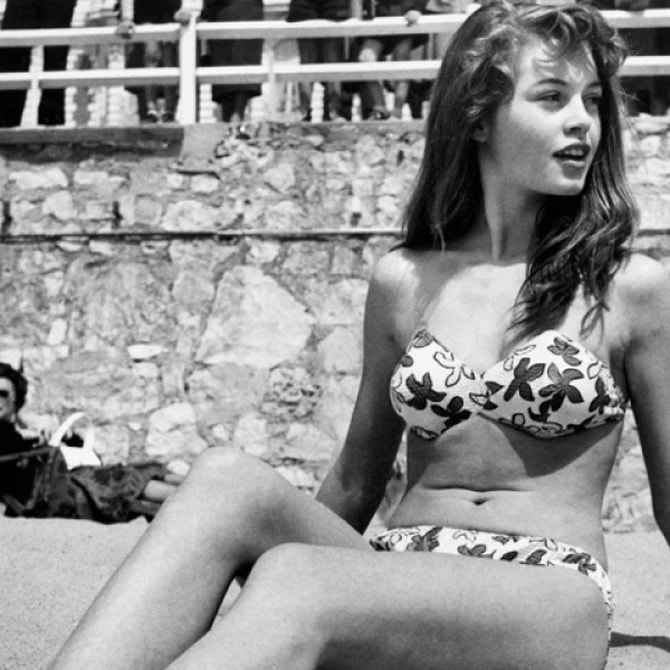 Elegant style icon wardrobe essentials: Brigitte Bardot in swimwear, a two piece bikini in floral print