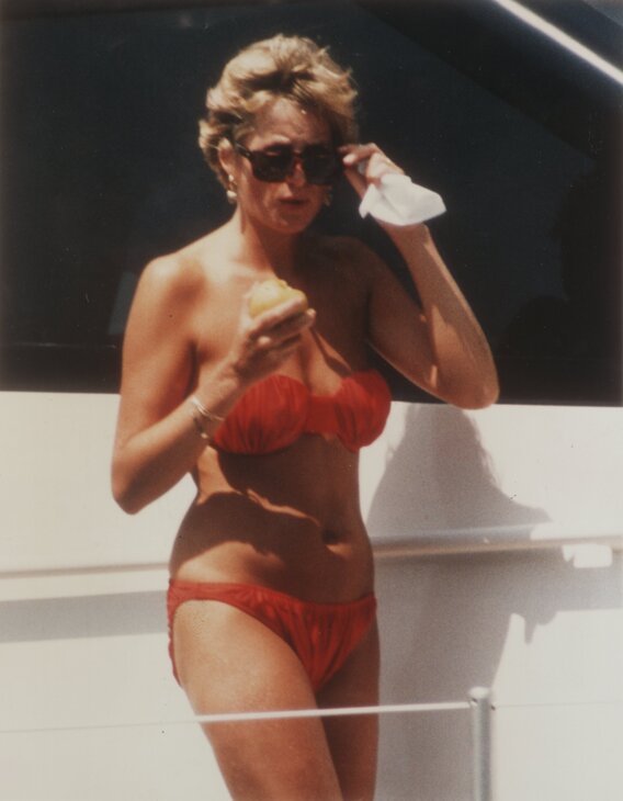 Elegant style icon wardrobe essentials: Princess Diana in swimwear, a two piece strapless coral bikini